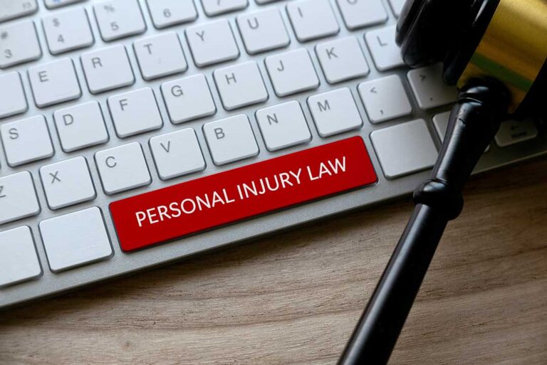 An injured adult reviews medical bills, wage records, and accident documents at a kitchen table.